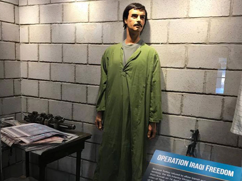 Operation Iraqi Freedom museum exhibit including man in green robe.